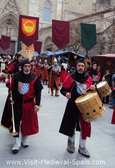Medieval knights in armour, drummers and musicians on parade in front of the cathedral, Manresa Spain.