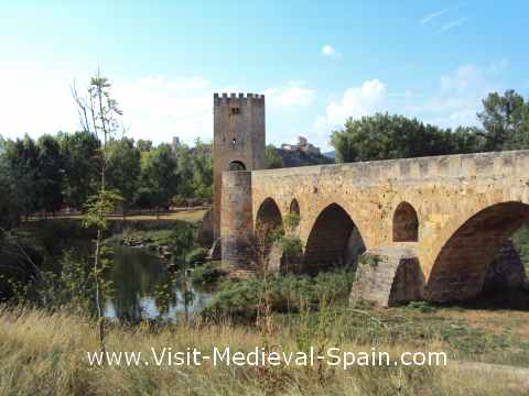 The medieval bridge of Frias,near Burgos Spain. Photo of the romanesque bridge over the river Ebro with the village visible in the background.