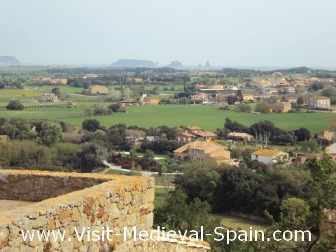 Beautiful views from the medieval village of Pals, near Girona in Catalonia, Spain. The countyside is very green since the photo was taken on a hazy day in spring, you can see the Mediteranean sea and the Medas Islands in the distance