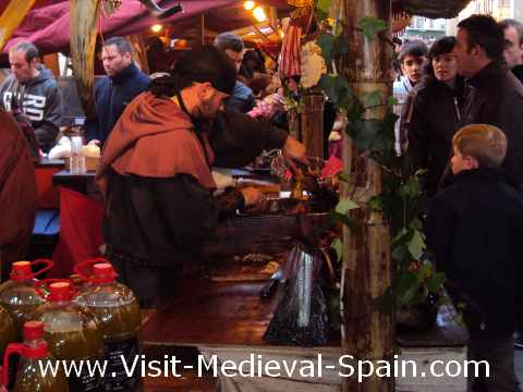 Stallholder carving meat at the 2012 medieval fair of Vic near Barcelona, Spain